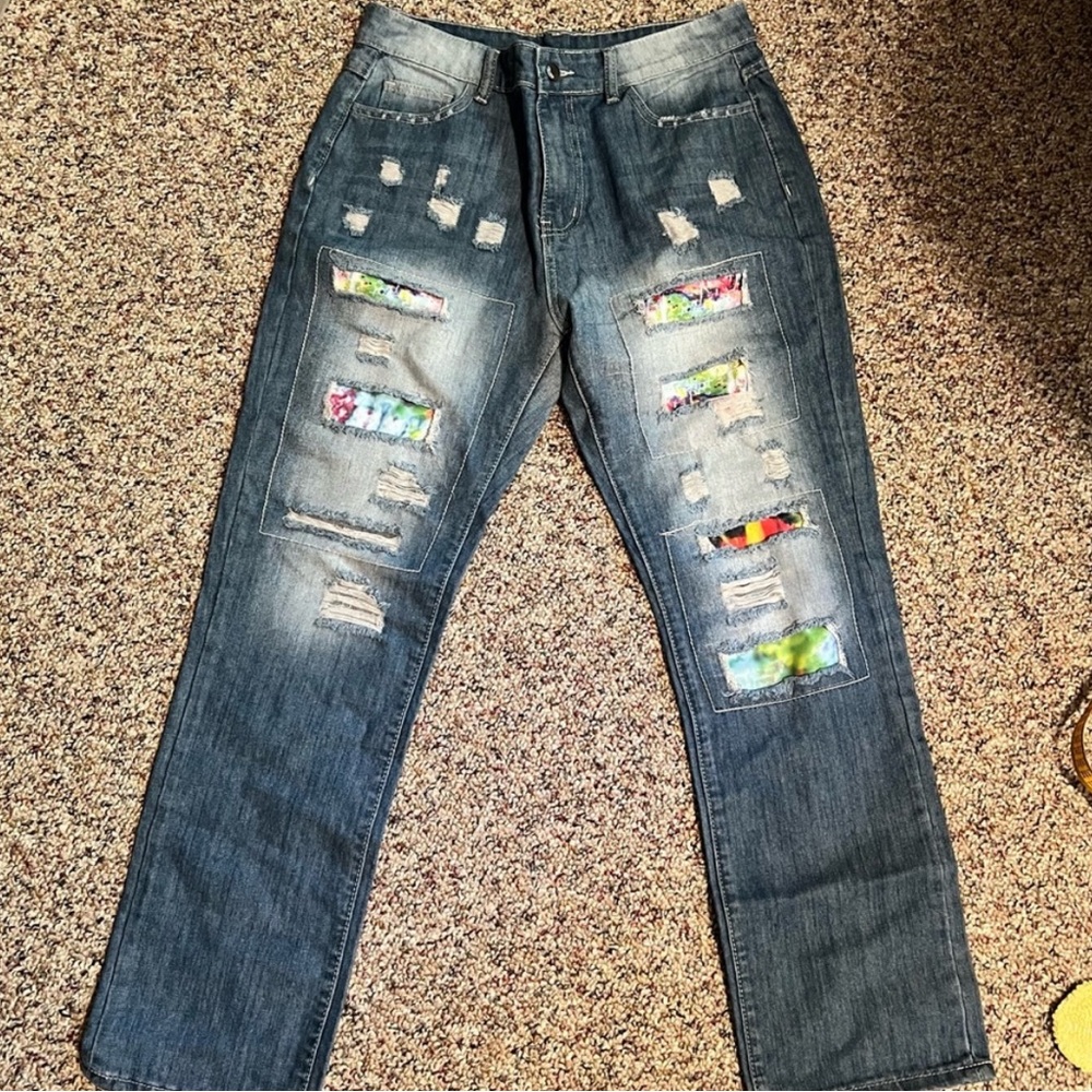 Distressed blue jeans with colorful patches underneath size 10
